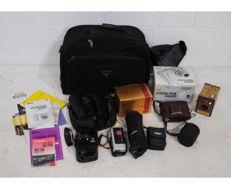 A Canon EOS 500 camera along with a Kodak Brownie Flash IV, a Retina IIa and various lenses etc including Osawa, Mamiya and S