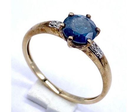 A 10K/375 gold blue and white diamond set ring, centre stone brilliant cut measures 6mm, 2 grams total. size N.