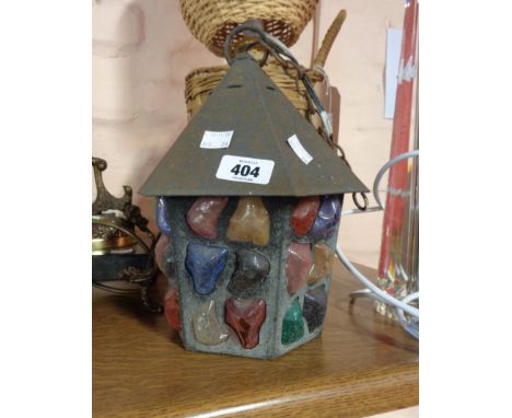 A vintage metal porch lantern with coloured fragments