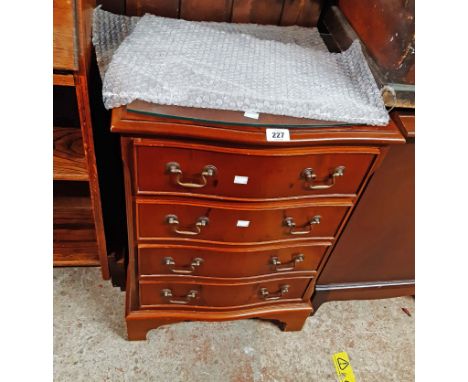 A 49.5cm reproduction yew serpentine front chest of four long graduated drawers, set on bracket feet