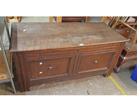 A 1.22m antique oak twin panel front coffer - incised initials DH, remains of baseboards and damage to one front upright join