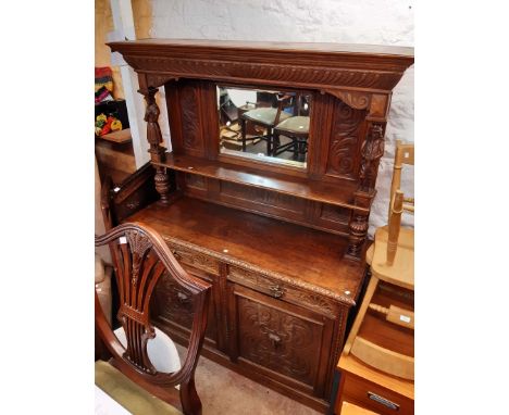 A 1.53m late 19th Century carved oak sideboard with high mirror set raised back with flanking male and female musician figura