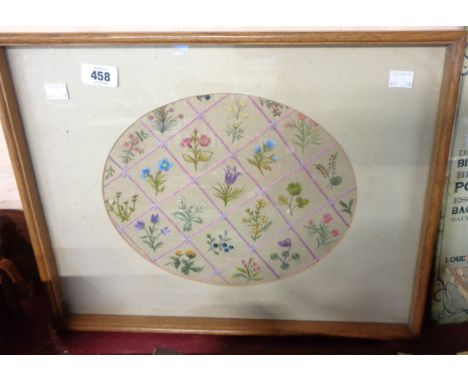 An embroidery panel, depicting flowering plants arranged on a chequerboard