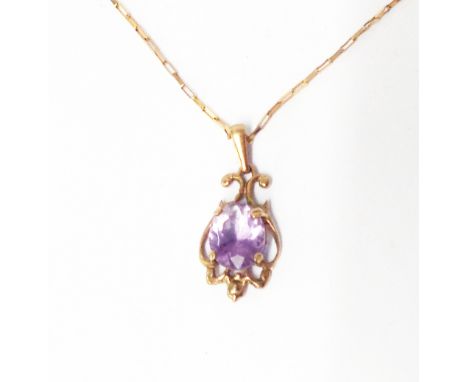 A marked 375 yellow metal amethyst drop pendant, on 9kt chain