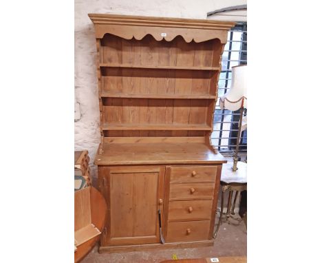 A 1.17m old waxed pine two part dresser with three shelf open plate rack over a base with flight of four short drawers and sh