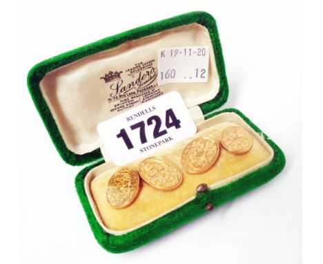 A pair of hallmarked 9ct. gold oval panel cufflinks with engraved foliate scroll decoration - cased