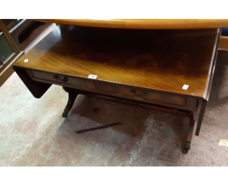 A 97cm reproduction mahogany and strung sofa style coffee table, set on lyre pattern standard ends with lion paw terminals an