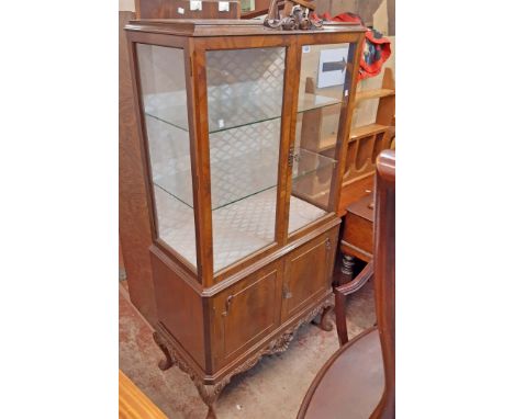 An 89cm flame mahogany veneered display cabinet with material lined interior and glass shelves enclosed by a pair of glazed p