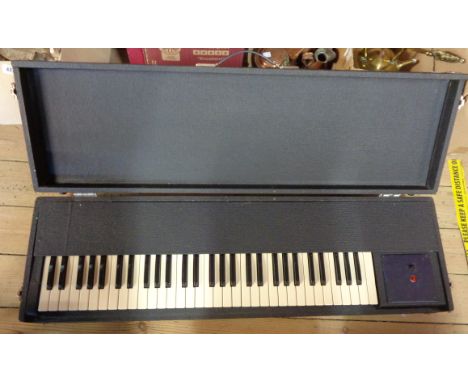 A vintage black cased organ keyboard