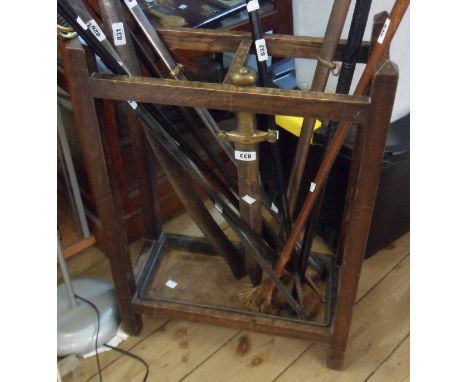 An early 20th Century stained oak umbrella/stick stand with metal drip tray to base