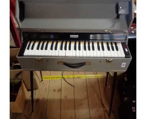 A vintage portable organ keyboard in grey case with detachable legs - retailed by Minns Music