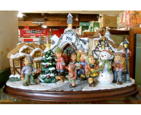 A Danbury Mint MJ Hummel Christmas Village with certificate