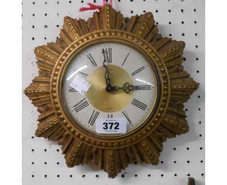 A vintage gilt plaster starburst wall timepiece with Smiths eight day floating balance movement