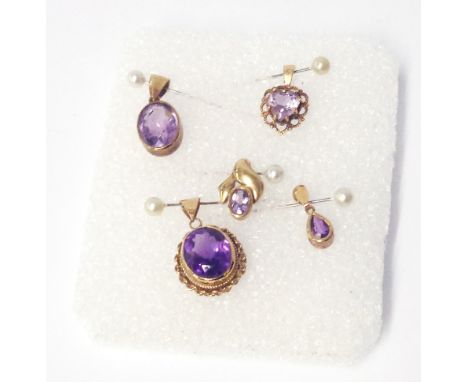 A hallmarked 375 gold amethyst pendant - sold with four other amethyst pendants