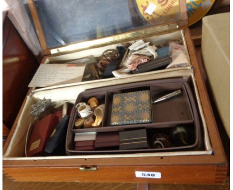 A table top display cabinet with various contents including musical lighter, marbles, etc.