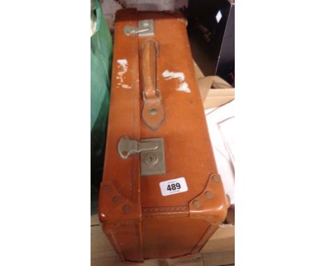 A suitcase containing various items including a CB radio, lamp, clock, etc.