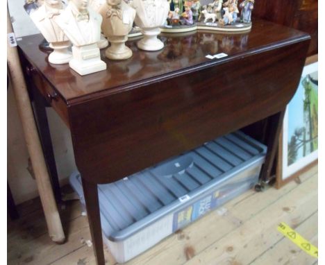 An 85cm 19th Century mahogany Pembroke table with drawer to one end, set on square tapered legs with brass caps and roller ca