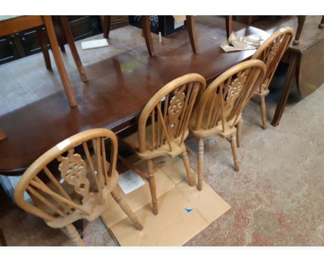 A set of four 20th Century hoop stick back kitchen chairs with solid sectional elm seats, set on turned supports