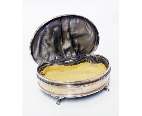 A silver kidney shaped ring box with piano hinged lid, set on paw pattern feet - worn