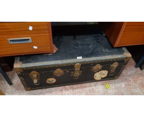 A 92cm vintage travelling trunk with tray fitted interior and various transit labels
