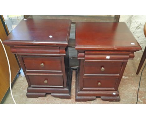 A pair of 46.5cm modern stained wood bedside chests in the Victorian style, each with blind frieze drawer and two drawers und