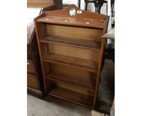 A 62cm early 20th Century stained wood three shelf open bookcase with heart pierced top