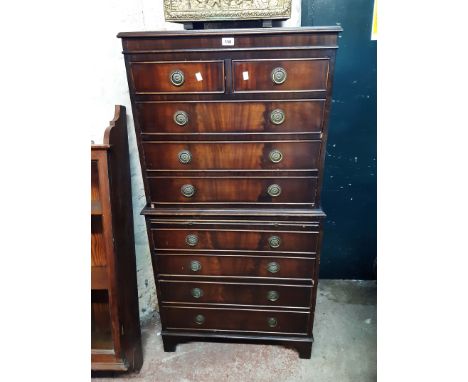 A 74cm reproduction mahogany chest on chest with two short and three long drawers over brushing slide and four further long d