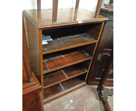 A 72cm old stained mixed wood four shelf open bookcase, set on plinth base