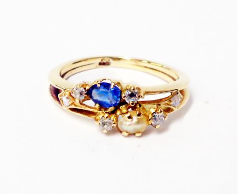 A marked 18 yellow metal ring set with tiny diamonds, seed pearl and sapphire