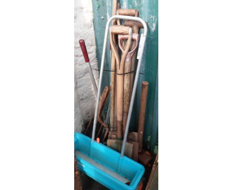 A bundle of assorted garden tools including spades, forks, rakes, hoes, etc.
