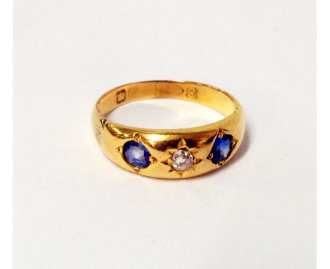 A hallmarked high carat gypsy set sapphire and diamond ring