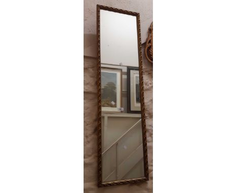 A vintage decorative gilt framed narrow oblong wall mirror