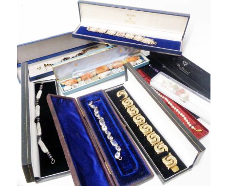 A collection of boxed costume jewellery bracelets including hardstone, cultured pearls and embossed panel examples