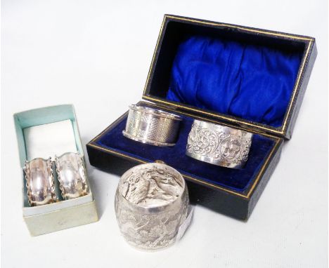 A fitted case containing a silver napkin ring with blank cartouche and another marked T80P - sold with a boxed pair of small 