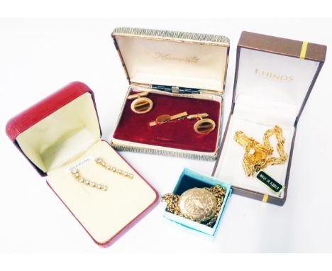 An engraved yellow metal locket on plated chain - sold with boxed vintage tiger's-eye cufflinks and tie clip set, gold plated