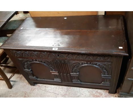 A 104cm 18th Century oak coffer with decorative arcaded and carved two panel front, set on moulded block feet