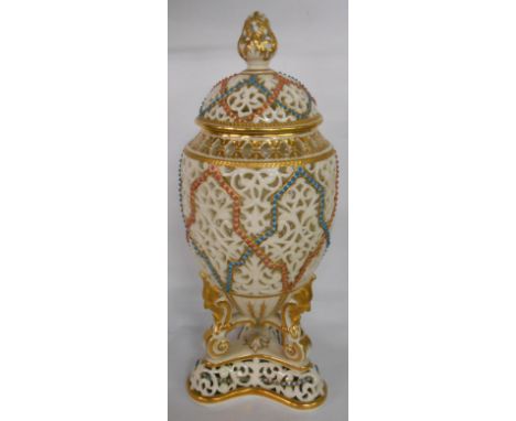 A 19th Century Graingers Worcester reticulated ovoid vase on mask and scroll trefoil base with gilt and jewelled decoration