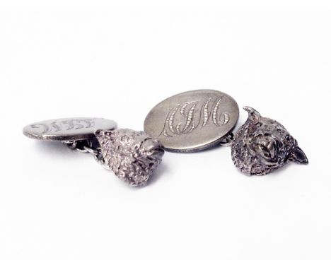 A pair of vintage hallmarked silver cufflinks with cast bull's heads and initials to oval panels