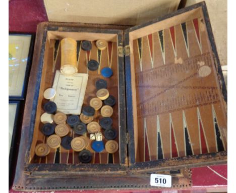 A tooled leather desk blotter - sold with a leather clad book pattern backgammon set - various condition