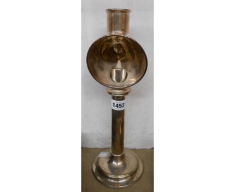 A vintage silver plated student's candle desk lamp with loaded circular base
