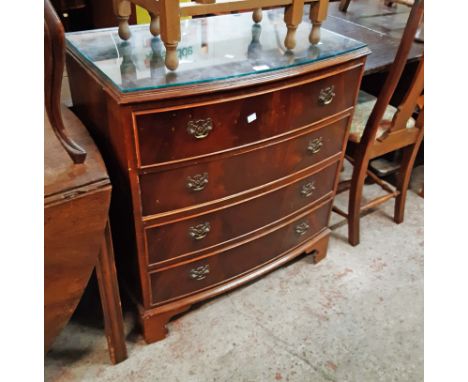 A 78cm reproduction mahogany bow front chest of four long drawers, set on bracket feet