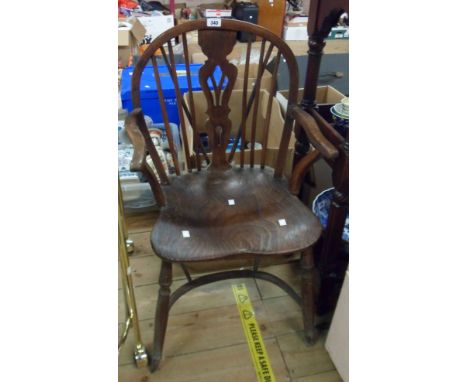 An antique hoop stick back elbow chair with moulded solid elm seat, set on turned supports and crinoline stretcher - old spli