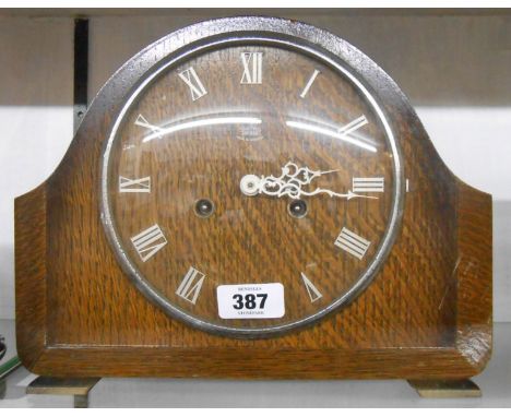 A mid 20th Century oak cased mantle clock with Smiths Enfield eight day gong striking movement