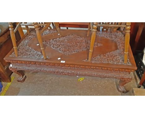 A 1.27m modern Chinese carved hardwood coffee table with profuse floral and foliate scroll decoration to top and sides, set o