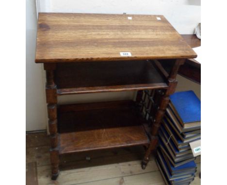 A 59cm late 19th Century oak lectern with two shelves and flanking decorative stick and ball lattice decoration, set on turne