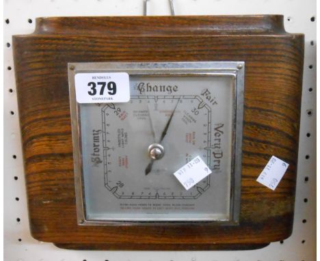 A mid 20th Century Art Deco style polished oak cased Shortland Smiths aneroid wall barometer
