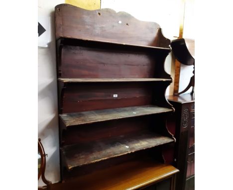 A 97cm antique wood grained pine wall hanging four shelf open bookcase with bracket to one end and shaped standard end the ot