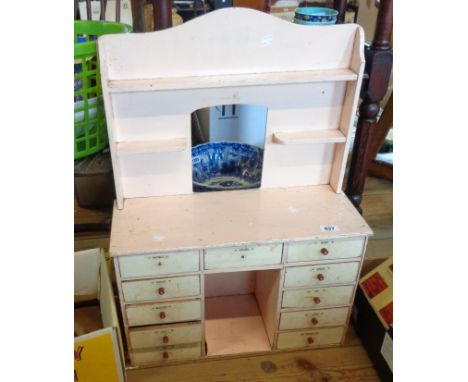 A handmade spice rack in the form of a kitchen dresser