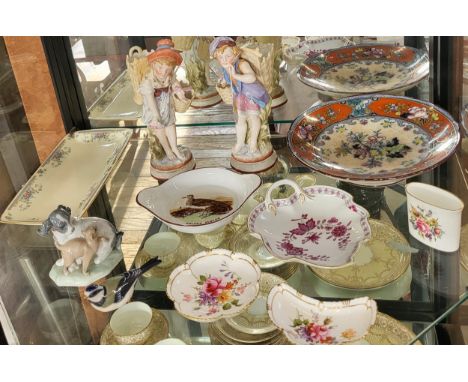 A pair of KPM figures of boy and girl with baskets 23cm to 24cm. Nao figure of a dog with kitten 11.5cm, Royal Copenhagen Blu