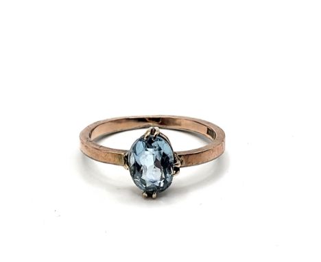 A 9ct rose gold ring set with an oval aquamarine stone. Size K 2.0gms.